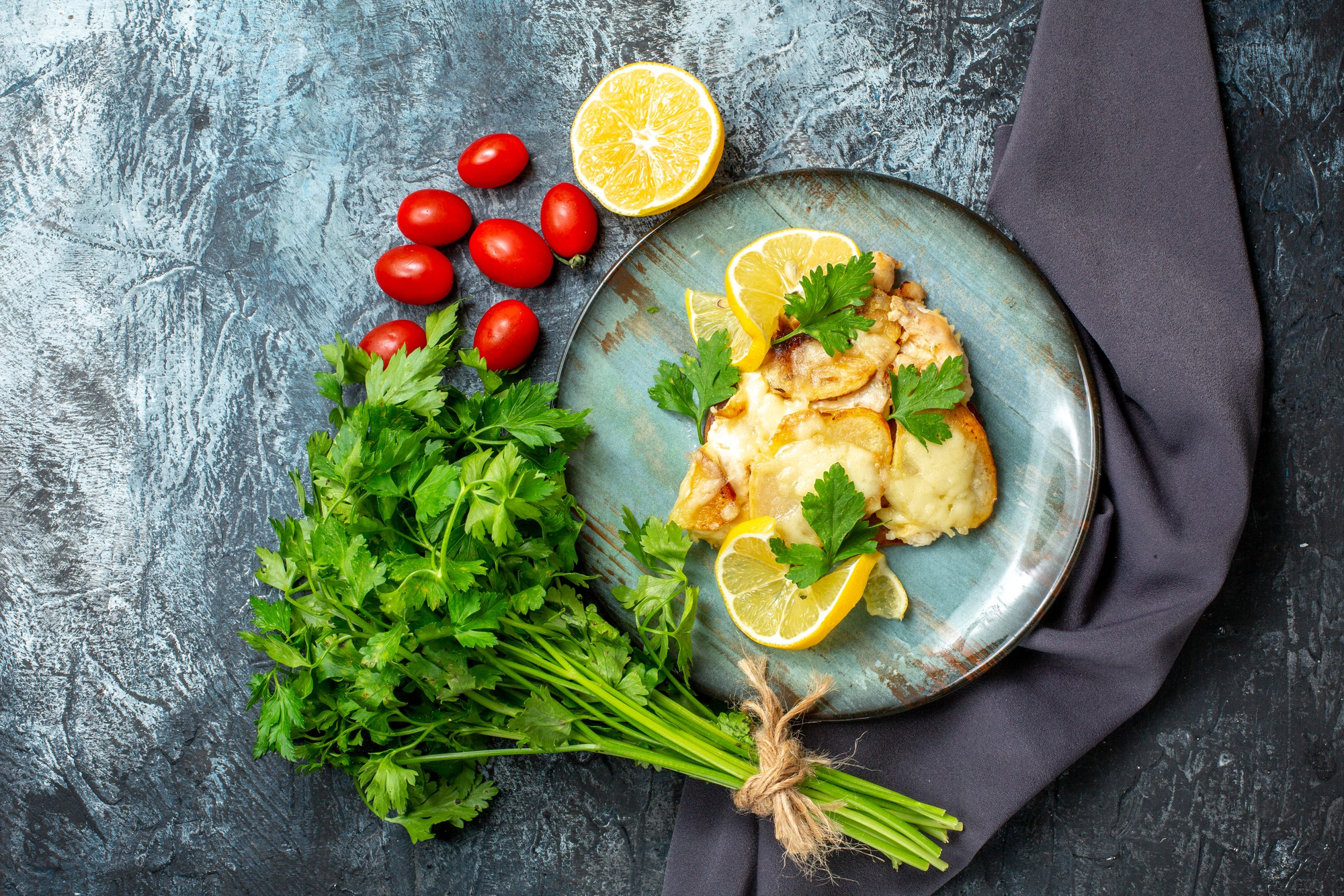 Ginger and calamansi grilled fish served with rice, mango, cucumber and fresh greens